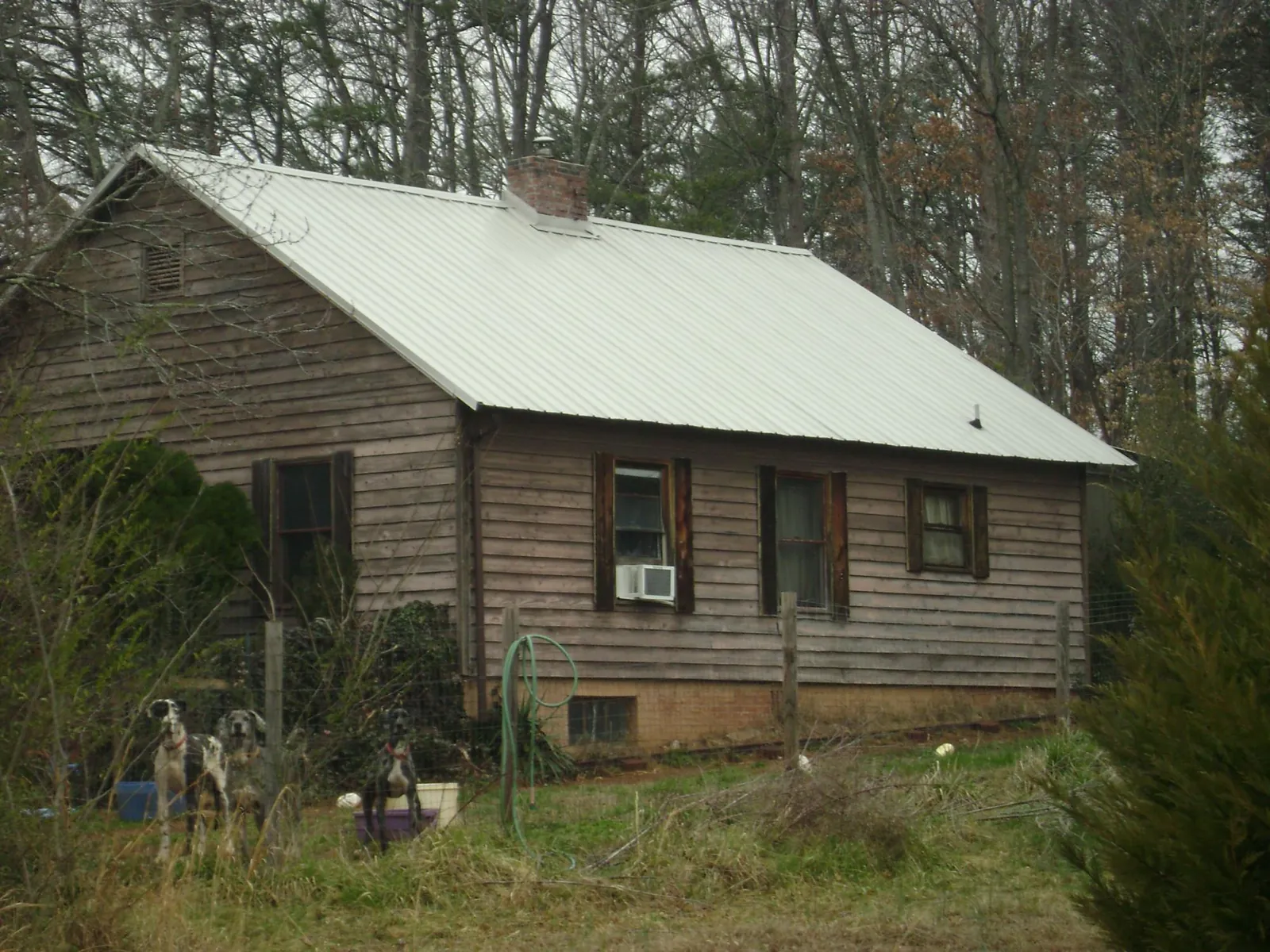 White metal roof on an old wood sided farmhouse, from a Metal Roof Installation job in Verona